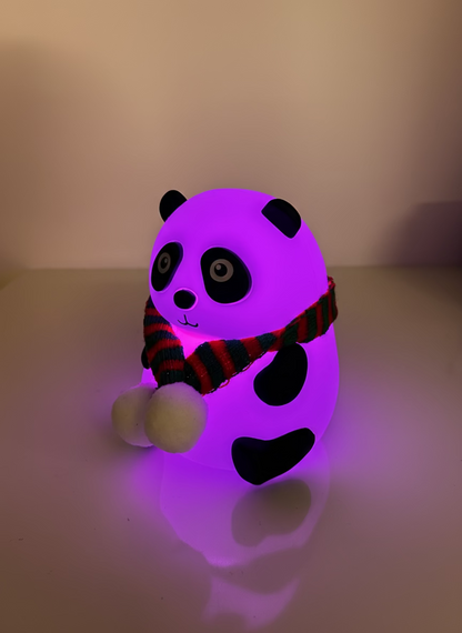 Glowing purple panda toy with a red and green striped scarf on a white background